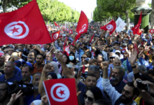 متظاهرون يرفعون الأعلام في شارع الحبيب بورقيبة حيث تونس تشتعل ومظاهرات حاشدة تطالب برحيل قيس سعيد